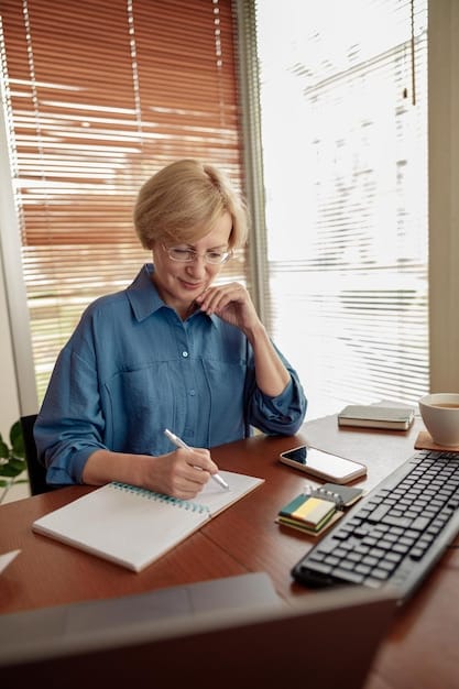 A person reviewing documents and using a calculator while sitting at a desk, symbolizing careful tax planning and preparation.